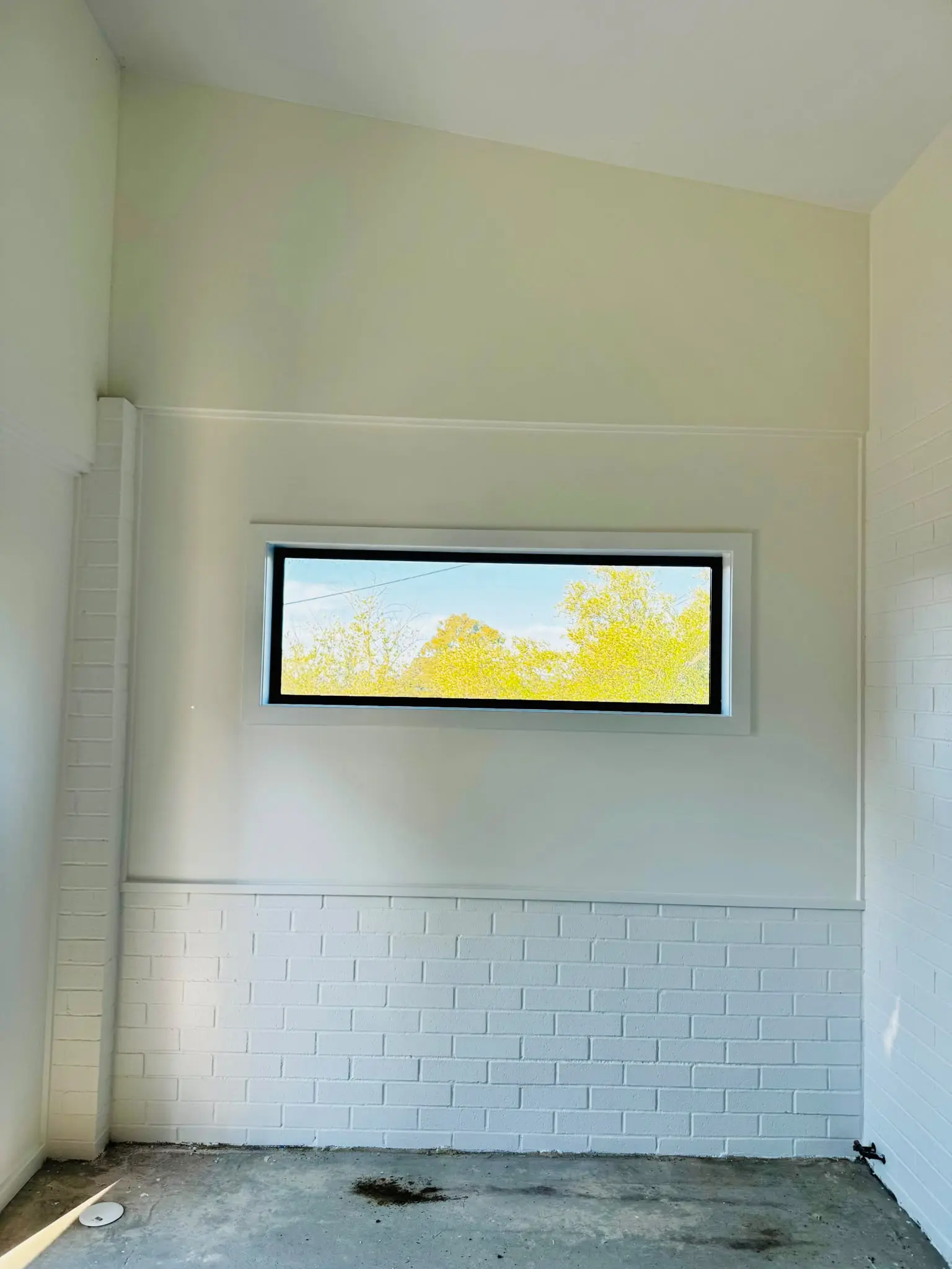 Interior white painted brick feature wall in Belconnen home
